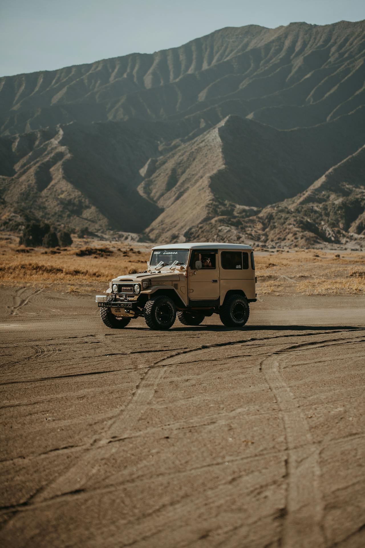 Black Jeep Wrangler on desert dirt road